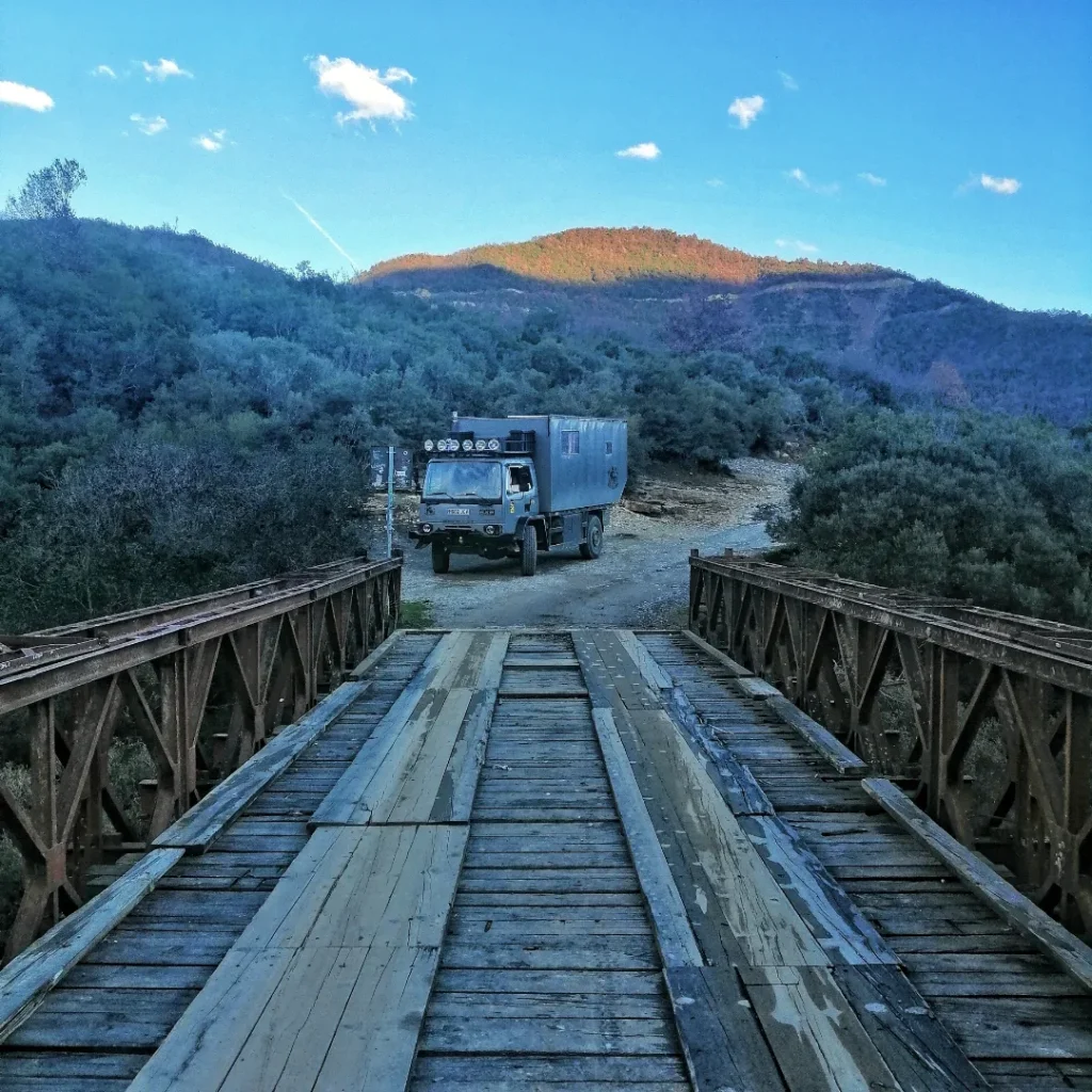 looking back across a rickety bridge and deciding not to risk taking the truck across. Overlanding in Albania can require quick thinking and a few detours